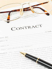 Business contract document with pen and glasses