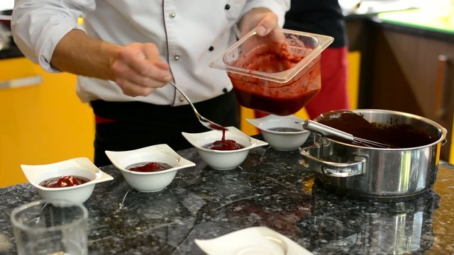 chef prepares dessert - chef puts strawberry on dessert