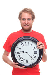 Bearded happy man holding big clock and smiling