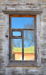 wall of the old wooden house with window