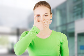 Attractive woman covering her mouth.