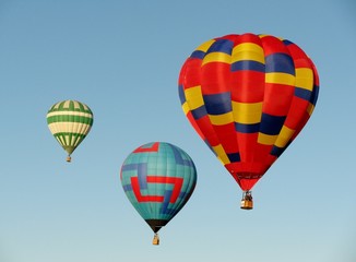 Three hot air balloons in blue sky