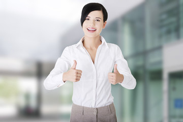 Business woman with thumbs up