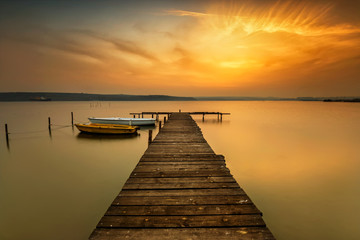Sunset view with boats at a lake coast near Varna, Bulgaria - obrazy, fototapety, plakaty