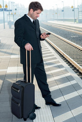man on business trip using his smartphone