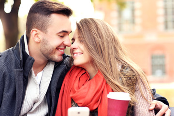 Happy couple on a bench in the park