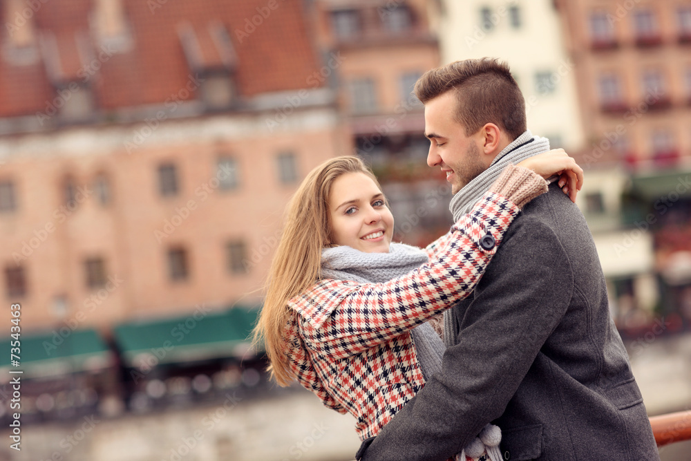 Wall mural Romantic couple hugging on a date in the city