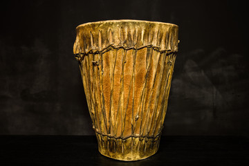 Handmade djembe drum on black background