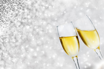 Champagne glasses against holiday lights