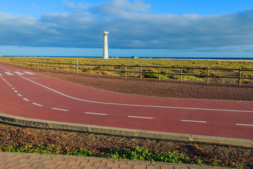 Obraz premium Bike lane and lighthouse view, Morro Jable beach, Fuerteventura