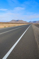 Road in desert landscape with mountains, Fuerteventura island