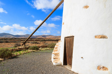 Old windmill in countryside landscape of Fuerteventura island