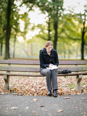 Fototapeta premium Woman Taking Notes in a Park