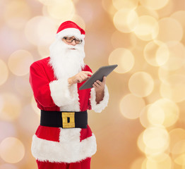 man in costume of santa claus with tablet pc