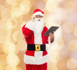 man in costume of santa claus with tablet pc