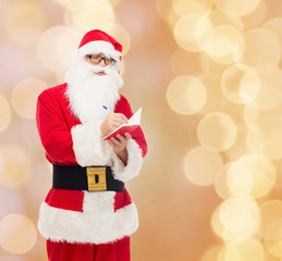 man in costume of santa claus with notepad