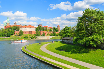 Tourist boat on Vistula river and Wawel Castle, Krakow, Poland