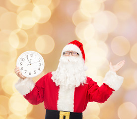 man in costume of santa claus with clock