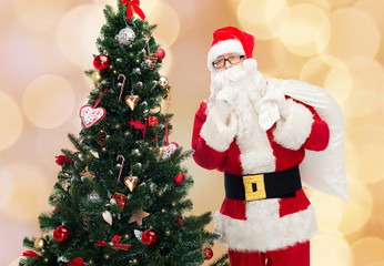 santa claus with bag and christmas tree