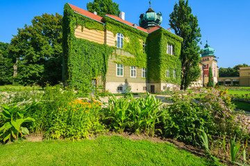 Fototapeta na wymiar Green gardens of Lancut castle on sunny summer day, Poland