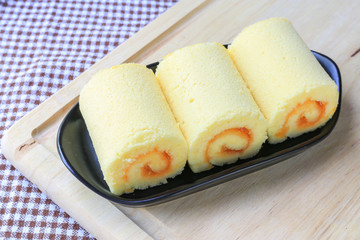 Orange roll cake on plate