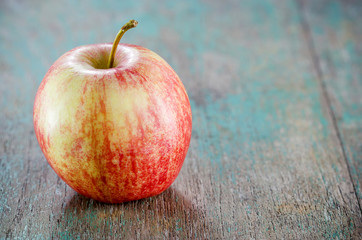 Ripe red apple on wooden background