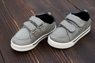 pair of grey shoes on wooden background