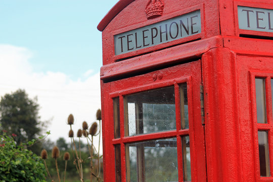 Freshly painted British telephone box painted in bright red