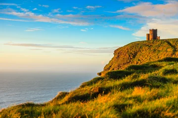 Rolgordijnen Cliffs of Moher at sunset - O Briens Tower in Co. Clare Ireland. © Voyagerix