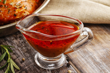 Honey and pepper red marinade in glass gravy boat - obrazy, fototapety, plakaty