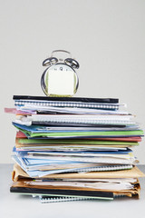 Stack of documents and alarm clock