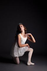Fototapeta na wymiar Image of smiling young ballerina posing in studio