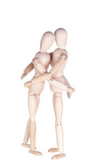 Two wooden hinged dummies embrace each other