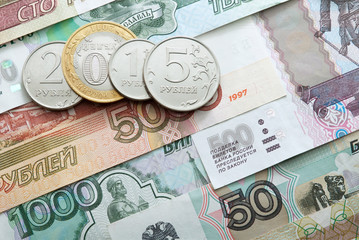 Number 2015 made of ruble coins on a ruble banknote background