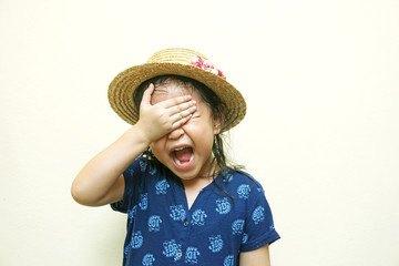 screaming little girl with hand closing her face