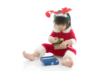 Cute asian baby wearing santa costume with present