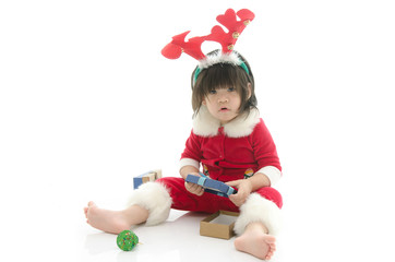 Cute asian baby wearing santa costume with present