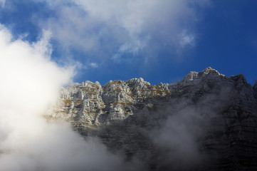 Fototapeta na wymiar Montasio mountain, Italy, surrounded by clouds