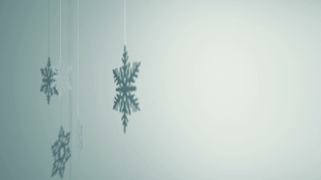 Three paper snowflakes hanging and rotating decoration