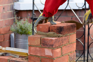 Bricklaying - laying a brick