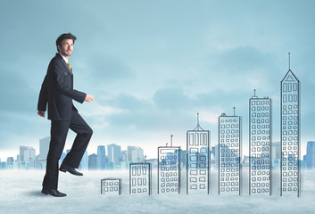 Business man climbing up on hand drawn buildings in city