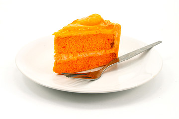 Orange cake with fork on white plate
