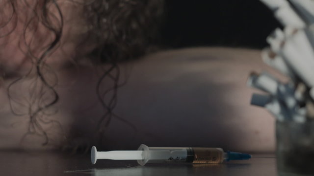 Young man preparing and using drugs. Heroin overdose. HD