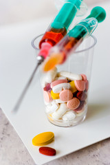 Different pills and syringe - health care