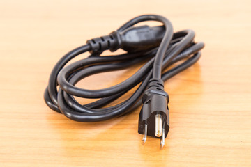 electric plug on wood background