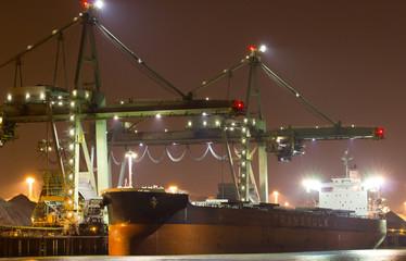 A large bulk carrier supplying iron-ore in a harbor