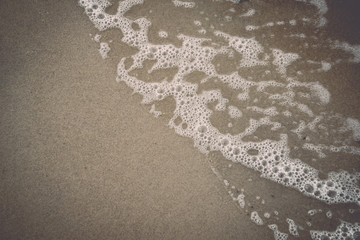 water waves rushing in sand. Vintage.