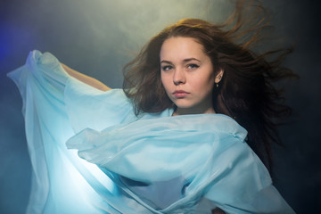 The beautiful girl with a blue fabric