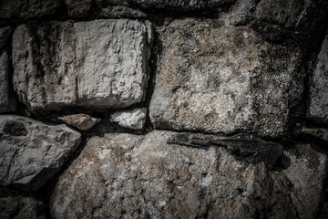 Natural stones are folded in wall. Background.