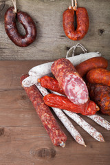 several types of sausages on a wooden background